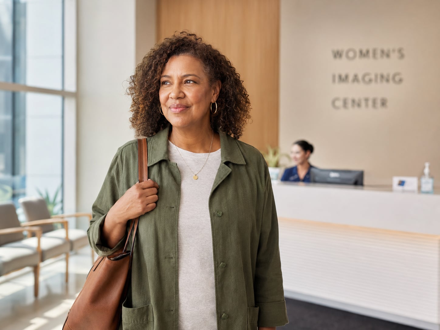 A woman walks into the lobby of a Women's Imaging Center clinic past a reception desk
